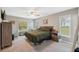 Bright bedroom with large windows, ceiling fan, and carpeted floor at 11034 Flock Ave, Weeki Wachee, FL 34613