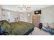 Bright bedroom featuring ceiling fan, dresser with TV, and carpeted floor at 11034 Flock Ave, Weeki Wachee, FL 34613