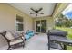 Outdoor patio space with a grill, seating area, and ceiling fan perfect for relaxation and entertaining at 11034 Flock Ave, Weeki Wachee, FL 34613