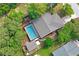 This aerial view showcases the home with a screened pool and the layout of the backyard and property lines at 1131 Bentley Ave, Spring Hill, FL 34608