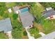 Aerial view of the property showing the home, pool, detached building and surrounding greenery at 1131 Bentley Ave, Spring Hill, FL 34608