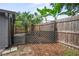 A backyard fence gate with leafy trees overhead at 1131 Bentley Ave, Spring Hill, FL 34608