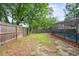 A fenced backyard with a pool, grass, and mulch at 1131 Bentley Ave, Spring Hill, FL 34608