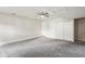 Finished basement area with neutral carpet, ceiling fan, and closet space at 1131 Bentley Ave, Spring Hill, FL 34608