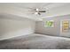 Spacious basement with neutral carpet, ceiling fan, and a window at 1131 Bentley Ave, Spring Hill, FL 34608