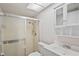 Well-lit bathroom with a glass door shower, white toilet, and vanity at 1131 Bentley Ave, Spring Hill, FL 34608