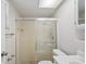 Bathroom with a glass-enclosed shower and a white vanity with a matching toilet at 1131 Bentley Ave, Spring Hill, FL 34608