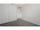 Bedroom featuring plush carpeting, neutral paint, and double door closet for ample storage at 1131 Bentley Ave, Spring Hill, FL 34608