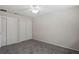 Bedroom featuring gray carpeting, neutral walls, a ceiling fan, and a double door closet at 1131 Bentley Ave, Spring Hill, FL 34608