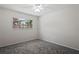 Bright bedroom with a window allowing natural light and a ceiling fan for comfort at 1131 Bentley Ave, Spring Hill, FL 34608