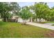 This home boasts a lush front lawn and mature trees, offering great curb appeal and a welcoming atmosphere at 1131 Bentley Ave, Spring Hill, FL 34608
