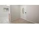 Bright foyer features tile flooring, a modern front door, and a view of the adjacent living area at 1131 Bentley Ave, Spring Hill, FL 34608