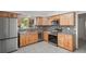 Updated kitchen with wooden cabinets, stainless steel appliances, and decorative backsplash at 1131 Bentley Ave, Spring Hill, FL 34608