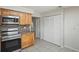 Updated kitchen featuring wood cabinets and stainless steel appliances, with storage closet at 1131 Bentley Ave, Spring Hill, FL 34608