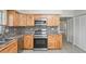 Updated kitchen featuring wooden cabinets, granite countertops, and stainless steel appliances at 1131 Bentley Ave, Spring Hill, FL 34608