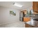 Bright kitchen featuring wood cabinets, stainless steel appliances, and tile flooring at 1131 Bentley Ave, Spring Hill, FL 34608