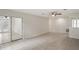 Bright and airy living room boasts tiled floors, a ceiling fan, and sliding glass doors to the pool area at 1131 Bentley Ave, Spring Hill, FL 34608