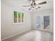 Bright living room featuring tiled flooring, a ceiling fan, and a window overlooking the exterior at 1131 Bentley Ave, Spring Hill, FL 34608