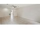 Open-concept living room featuring tile floors, ceiling fan, and access to the backyard at 1131 Bentley Ave, Spring Hill, FL 34608
