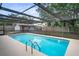 Inviting screened-in pool, perfect for relaxation and recreation at 1131 Bentley Ave, Spring Hill, FL 34608