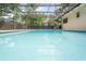 Backyard featuring an inviting screened-in pool at 1131 Bentley Ave, Spring Hill, FL 34608