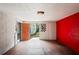 An empty shed interior with a red block wall, concrete floor, and open door at 1131 Bentley Ave, Spring Hill, FL 34608