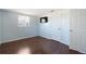 Cozy bedroom with neutral wall color, laminate flooring, and a large window at 11524 Meadow Dr, Port Richey, FL 34668