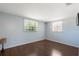 Bright bedroom features wood floors, and natural light streaming through large windows at 11524 Meadow Dr, Port Richey, FL 34668