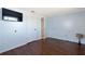 A charming bedroom with laminate floors, light blue walls, and a wall-mounted television at 11524 Meadow Dr, Port Richey, FL 34668