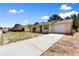 Street view of a single-story home featuring an attached garage and long concrete driveway at 11524 Meadow Dr, Port Richey, FL 34668