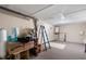 A well-lit garage featuring textured floors, ample storage, and a ladder for easy access at 11524 Meadow Dr, Port Richey, FL 34668
