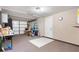 A spacious garage with textured floors, a service door, and an abundance of storage space at 11524 Meadow Dr, Port Richey, FL 34668