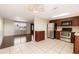 Open kitchen design with stainless appliances, dark wood cabinetry, and tile flooring at 11524 Meadow Dr, Port Richey, FL 34668