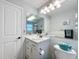Clean bathroom with white accents, updated fixtures, and ample lighting at 11722 Carissa Ln # 49A, New Port Richey, FL 34654