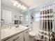 Fresh bathroom featuring a wide mirror, white cabinets, and updated fixtures at 11722 Carissa Ln # 49A, New Port Richey, FL 34654