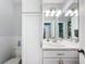 Bright bathroom with a vanity, marble countertop, ample storage, and a toilet nearby at 11722 Carissa Ln # 49A, New Port Richey, FL 34654