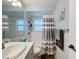 Bright bathroom with white tile, marble countertops, and modern fixtures at 11722 Carissa Ln # 49A, New Port Richey, FL 34654