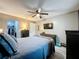 Bright bedroom featuring a wall-mounted TV and well-appointed dark wood furniture at 11722 Carissa Ln # 49A, New Port Richey, FL 34654