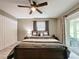 Comfortable bedroom featuring a ceiling fan, closet, and sliding door access at 11722 Carissa Ln # 49A, New Port Richey, FL 34654