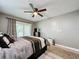 Cozy bedroom with a ceiling fan, sliding door, and neutral color scheme at 11722 Carissa Ln # 49A, New Port Richey, FL 34654
