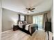 Bright bedroom with a ceiling fan, area rug, and sliding door to the exterior at 11722 Carissa Ln # 49A, New Port Richey, FL 34654