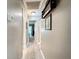 Hallway with gray walls, white trim, and modern light fixtures leads to bedrooms at 11722 Carissa Ln # 49A, New Port Richey, FL 34654
