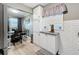 Well-lit kitchen with white subway tile, updated countertops, and gray flooring at 11722 Carissa Ln # 49A, New Port Richey, FL 34654