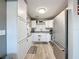 Clean kitchen featuring white cabinets, stainless steel appliances, and laminate flooring at 11722 Carissa Ln # 49A, New Port Richey, FL 34654