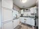 Bright kitchen with white cabinets, subway tile backsplash, and modern appliances at 11722 Carissa Ln # 49A, New Port Richey, FL 34654