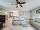 Spacious living room featuring hardwood floors, a ceiling fan, neutral walls, and a comfortable seating arrangement at 11722 Carissa Ln # 49A, New Port Richey, FL 34654