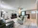 Inviting living room with hardwood floors, a ceiling fan, neutral walls, and comfortable seating, perfect for relaxation at 11722 Carissa Ln # 49A, New Port Richey, FL 34654