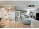 Spacious living room with wood floors, a ceiling fan, and comfortable seating, perfect for relaxing and entertaining at 11722 Carissa Ln # 49A, New Port Richey, FL 34654