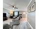 Cozy living room with a ceiling fan, neutral walls, hardwood floors, and a comfortable seating arrangement at 11722 Carissa Ln # 49A, New Port Richey, FL 34654