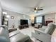 Comfortable living room with a ceiling fan, neutral walls, hardwood floors, and plush seating for a relaxed atmosphere at 11722 Carissa Ln # 49A, New Port Richey, FL 34654